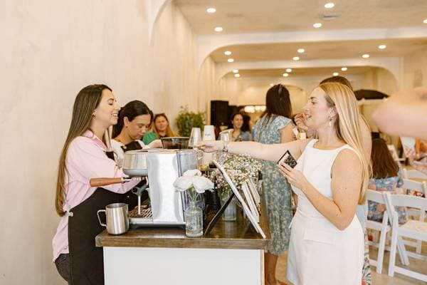 Barista serving guests at event